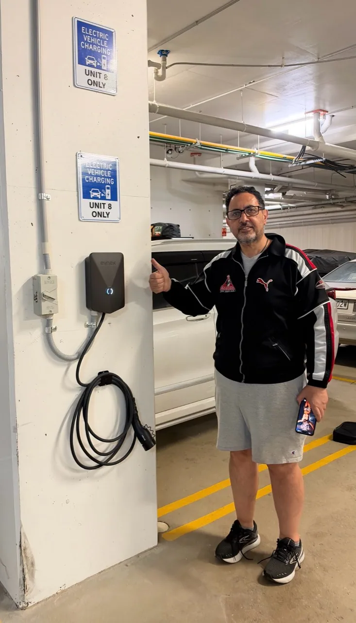 Customer beside an Evnex charger in a strata car park